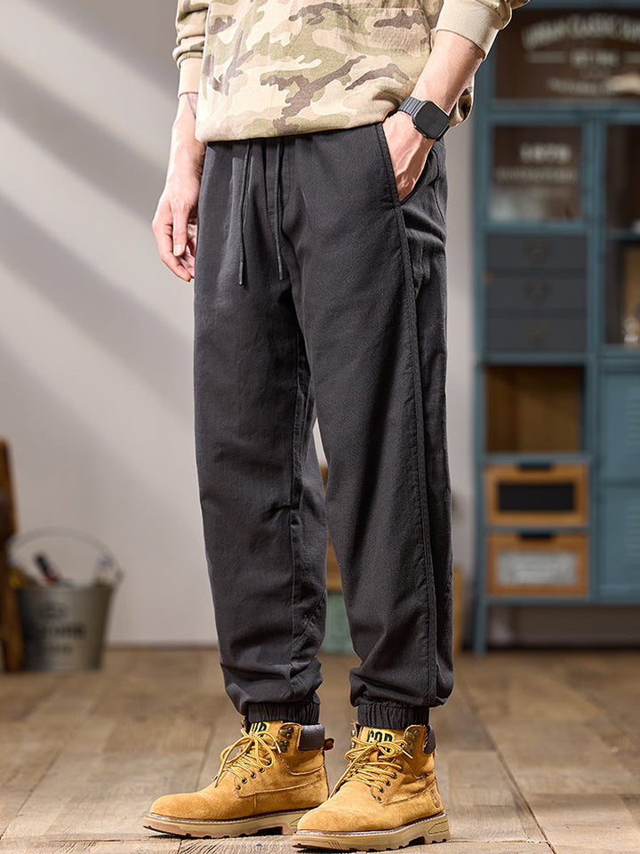 Pantalones casuales de algodón puro para hombre, corte relajado, múltiples bolsillos y puños elásticos